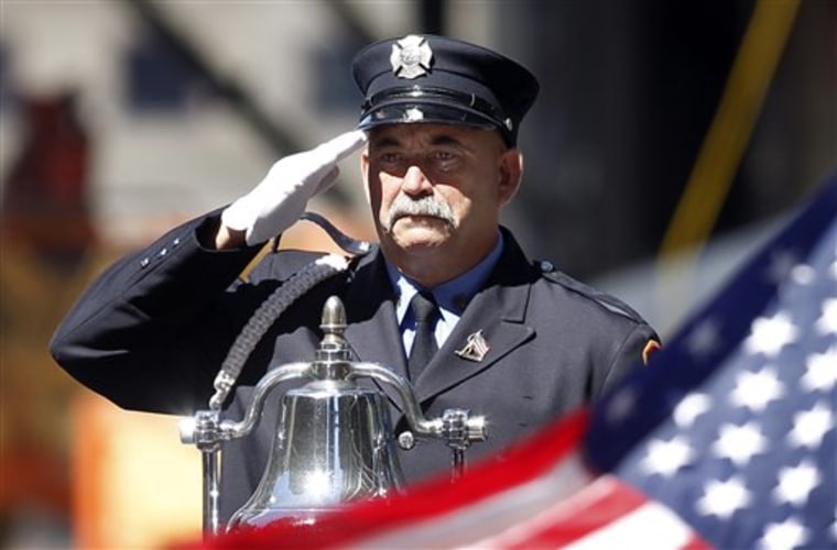 A firefighter salutes as taps is played for victims of the Sept. 11, 2001 attacks, during a commemoration ceremony at Zuccotti Park, adjacent to ground zero, on the ninth anniversary of the terrorist attacks on the World Trade Center on Saturday in New York. 